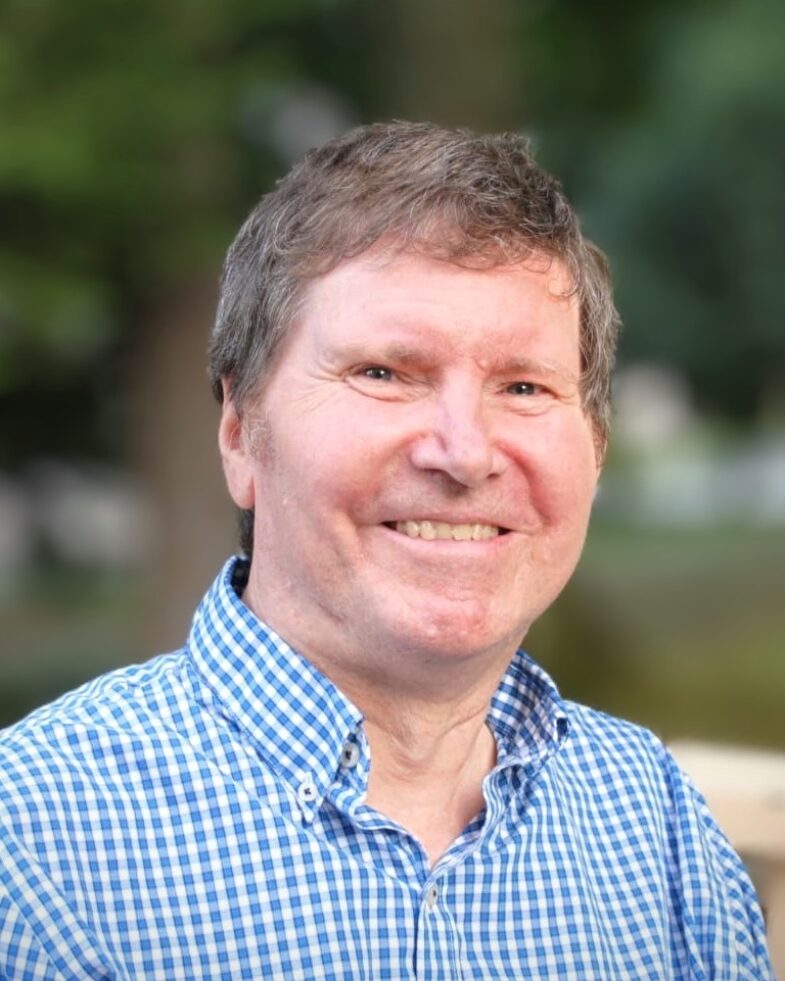 Aubrey Haschick, smiling, in a blue checked shirt