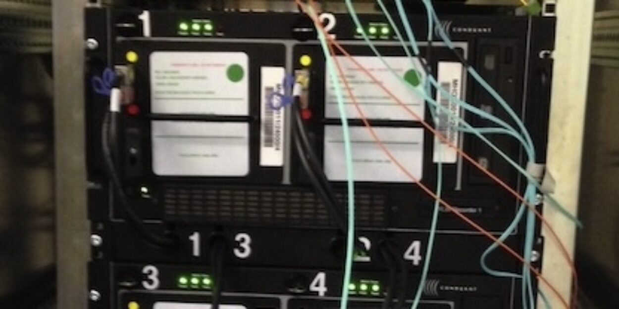 A rack of numbered computer hard drives and receiver technology